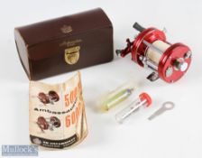 ABU Ambassadeur 6000 multiplier reel, in red, numbered to foot 030902, drag adjuster to end, sliding