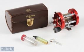 ABU Ambassadeur 6000 multiplier reel, in red, numbered to foot 010600, sliding line guide, runs