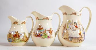 Royal Doulton Bunnykins graduated collection of Albion jugs, tallest 15cm. (3)