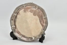 AN ELIZABETH II SILVER WAITER WITH GADROONED PIE CRUST RIM, on three scrolled feet, stamped STERLING