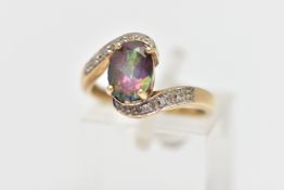 A 9CT GOLD GEM SET RING, designed with a four claw set, oval cut mystic coated topaz, curved cross