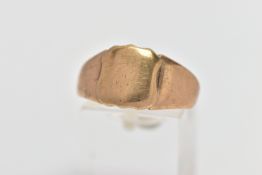 A YELLOW METAL SIGNET RING, of a polished (worn) shield shape, tapering shoulders leading onto a