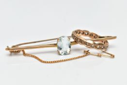 A YELLOW METAL AQUAMARINE BROOCH AND A YELLOW METAL PASTE RING, the brooch designed as an oval cut