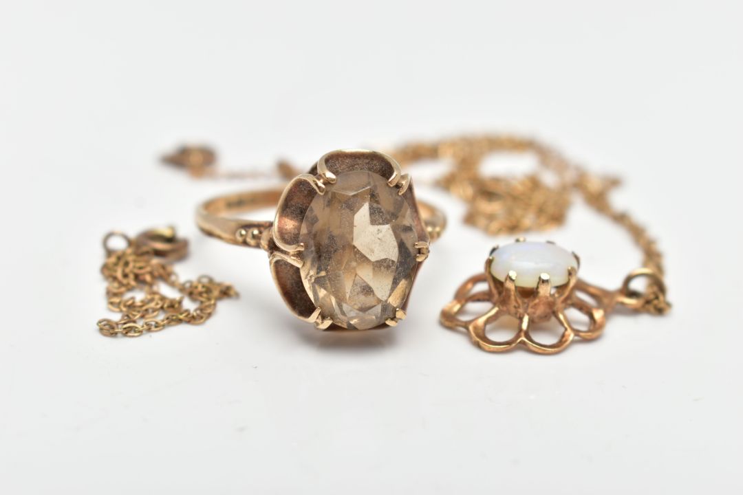 A 9CT GOLD RING AND PENDANT, an oval cut smoky quartz, prong set with an open work scalloped - Image 1 of 4