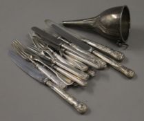 A small quantity of silver and silver handled cutlery, and a plated wine funnel. 115.