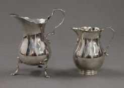 Two small silver cream jugs. The largest 11 cm high. 197.9 grammes.