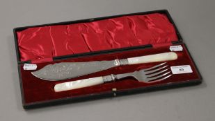 A cased pair of mother-of-pearl handled fish servers with silver collars.
