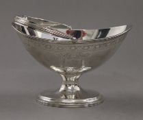 A silver footed bon-bon dish of navette form with swing handle. 14.5 cm wide. 148.3 grammes.