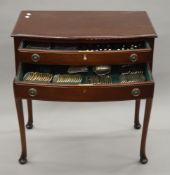 A fitted mahogany canteen table of silver cutlery, comprising: 12 dessert forks, 12 table forks,