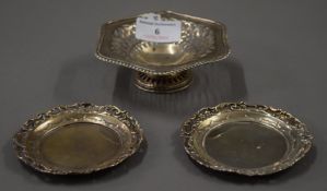 Two small silver pin trays and a small silver bon-bon dish. The latter 11.5 cm wide. 122.9 grammes.