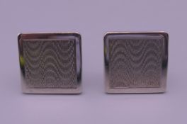 A pair of engine turned silver cufflinks. 1.75 cm square.