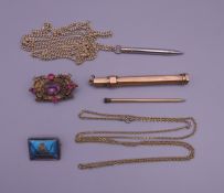 A 9 ct gold propelling pencil, two brooches, etc. The former 9 cm long and 11.