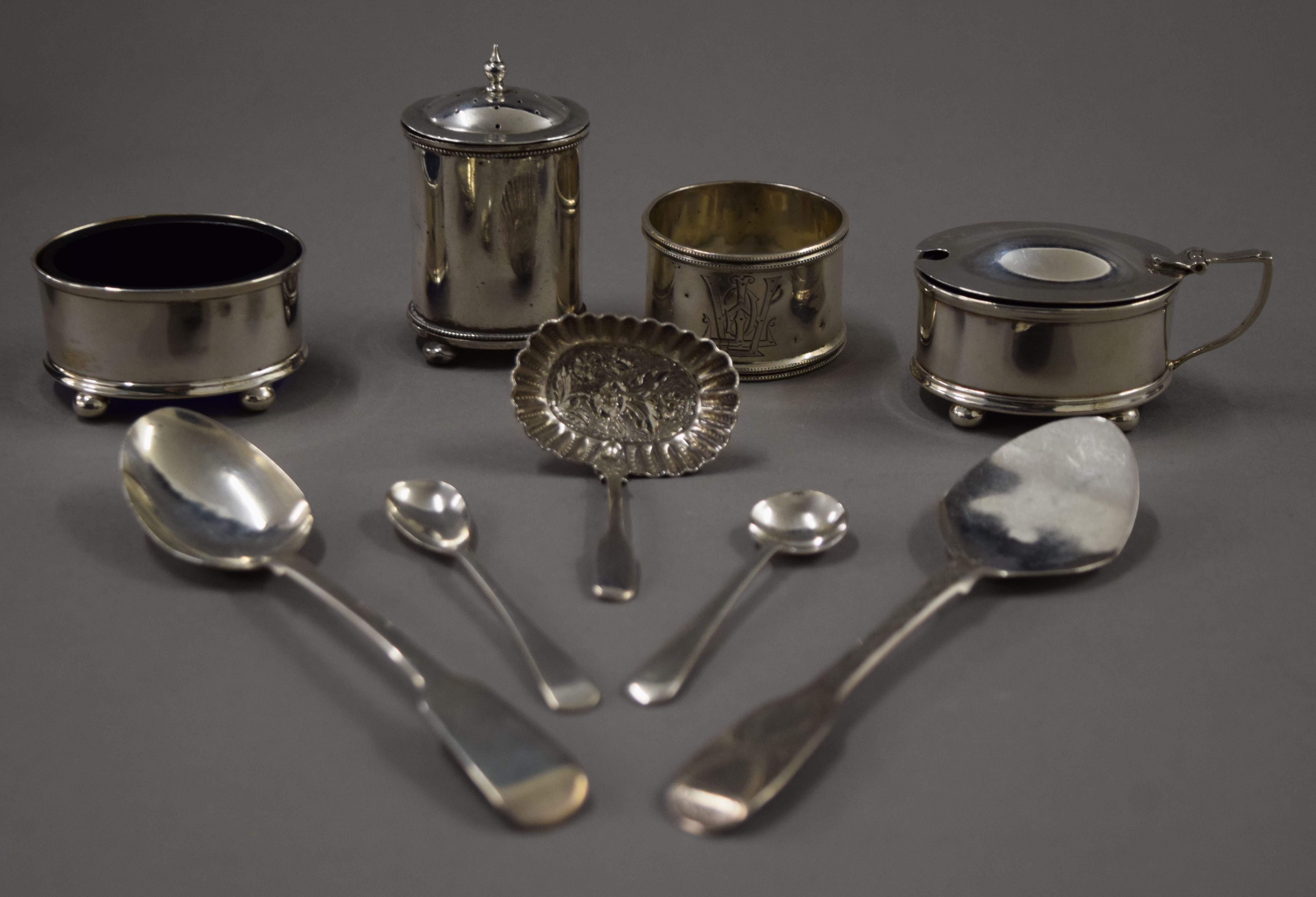 A cased silver cruet set, spoons and a napkin ring. 167.8 grammes.