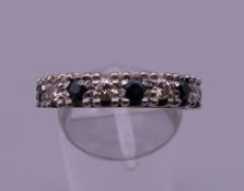 An 18 ct gold diamond and sapphire ring. Ring size O. 5.6 grammes total weight.