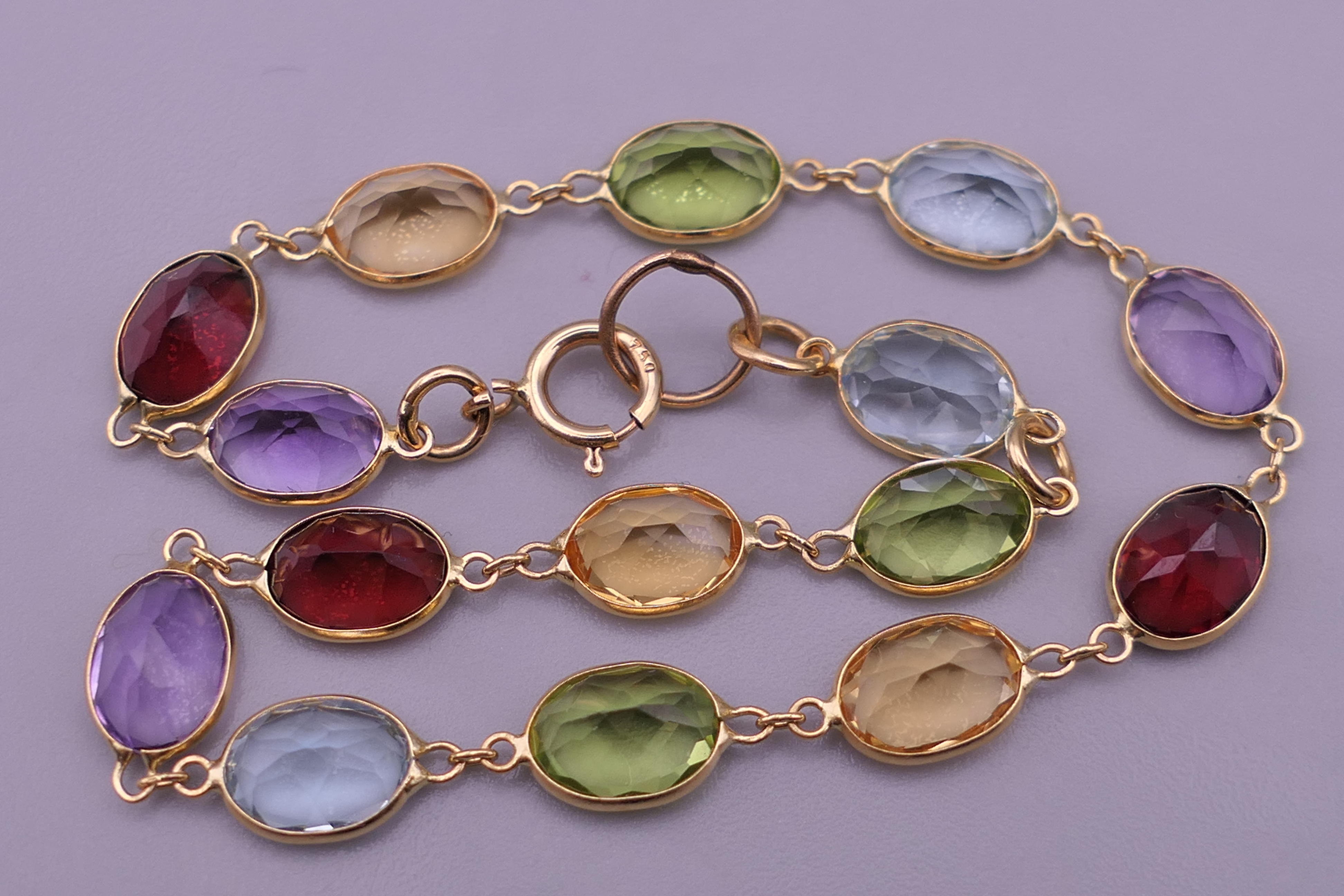 An 18 ct gold mutli-gem set bracelet. 16 cm long. 3.9 grammes total weight. - Image 2 of 4