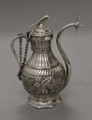 An Eastern unmarked white metal ewer. 13.5 cm high. 191.2 grammes.