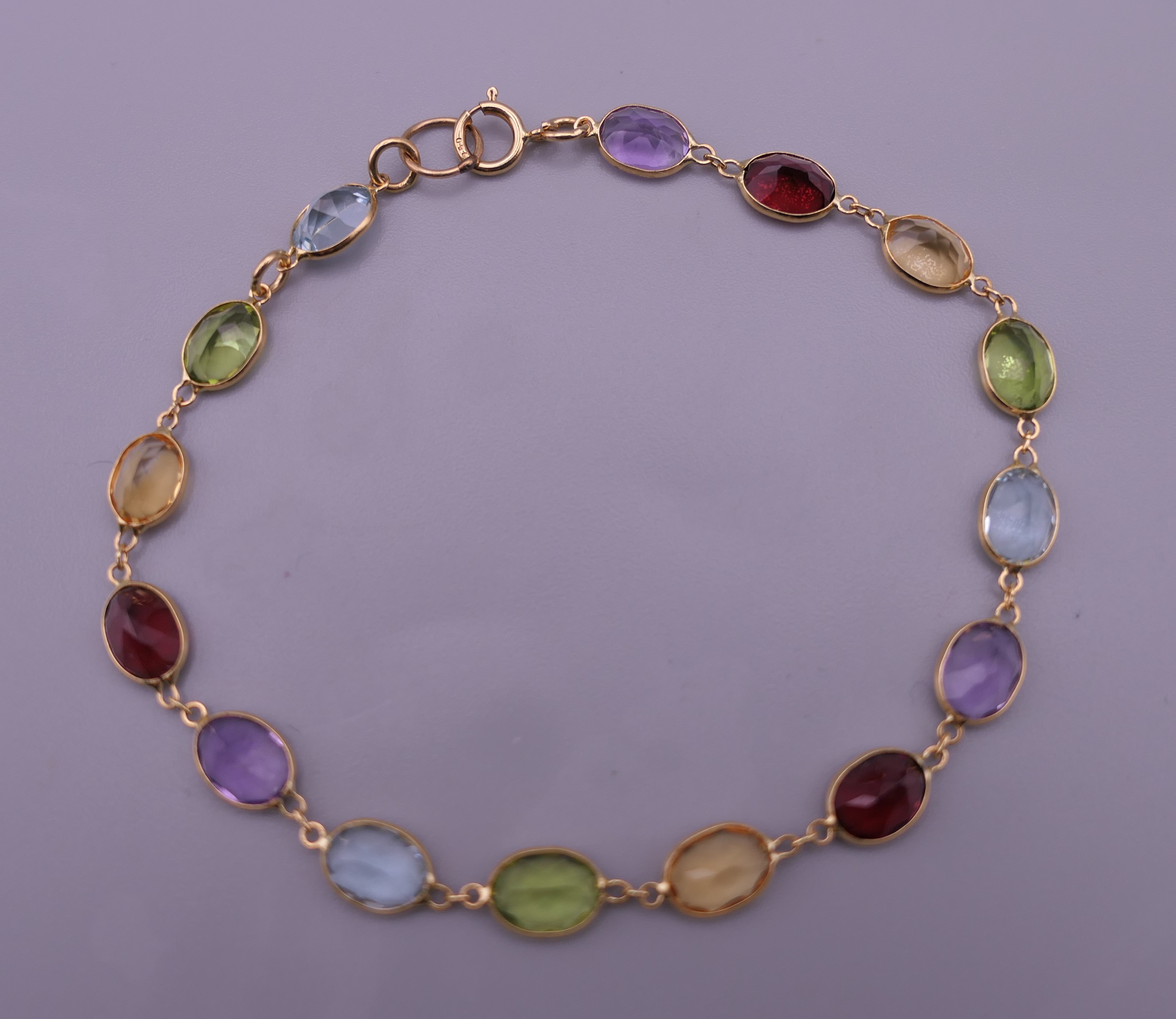An 18 ct gold mutli-gem set bracelet. 16 cm long. 3.9 grammes total weight.
