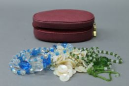 A jewellery box containing three necklaces.
