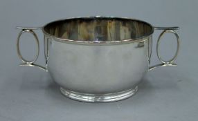A small silver two handled bowl, hallmarked for Sheffield 1915 Edward and Sons. 6 cm high. 4.