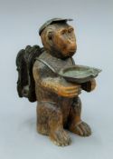 A late 19th/early 20th century Blackforest carved wooden monkey smokers compendium. 18 cm high.