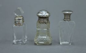 Three small scent bottles, each with silver mounts. The largest 6.5 cm high.