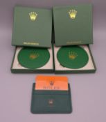 Two boxed Rolex coasters and a credit card holder.