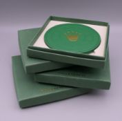 Four boxed Rolex coasters. Each box 12 cm square.