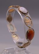 A Chinese 14 ct gold multi coloured jade bracelet. 17.5 cm long. 12.8 grammes total weight.