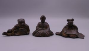 Three Japanese patinated lead figures. The largest 3.5 cm high.