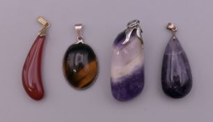 Four mineral specimen pendants. The largest 4.5 cm high.