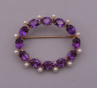 A 14 ct gold amethyst and pearl brooch. 4 cm wide. 8.1 grammes total weight.