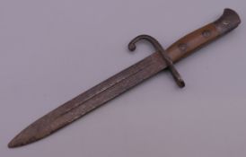 A vintage miniature bayonet. 18.5 cm long.