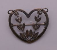 A Georg Jensen silver brooch, boxed. 3 cm wide.