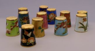 Twelve cloisonne thimbles.