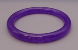 A lavender jade bangle. 6 cm inner diameter.