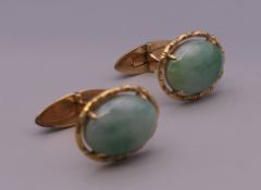A pair of 14 ct gold jade cufflinks. 2 cm high. 10.3 grammes total weight.