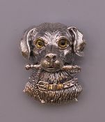 A silver dog form brooch. 3 cm high.
