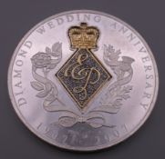 A diamond set pure silver medallion commemorating Queen Elizabeth II and Prince Phillips Diamond