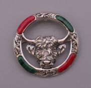A silver brooch formed as a bull. 4 cm diameter.