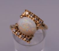 A 14 ct gold opal and diamond ring. Ring N/O. 4.8 grammes total weight.