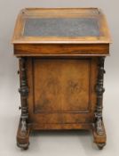 A Victorian walnut davenport. 53 cm wide.