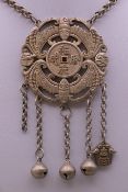 A Chinese pendant on chain. The pendant 6 cm wide.