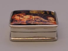 A silver pill box depicting a nude. 3 cm wide.