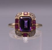 An Art Deco style 9 ct gold amethyst, ruby and diamond ring. Ring size O.