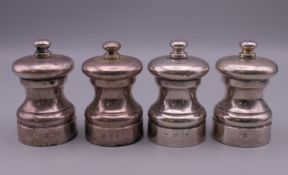 Two pairs of silver salts and pepper grinders. 7 cm high.