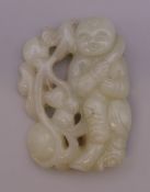A pierced jade carving of a boy. 6 cm high.