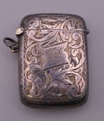 A George V silver vesta engraved with foliage, hallmarked for Henry Williamson Ltd, Birmingham,