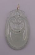 A gold mounted icy jade pendant. 5.5 cm high.