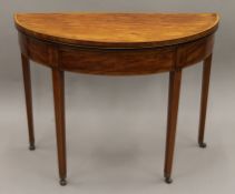 A Georgian satinwood crossbanded sabicu demi lune tea table. 98 cm wide.