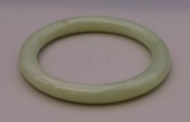 A celadon jade bangle. 6 cm inner diameter.